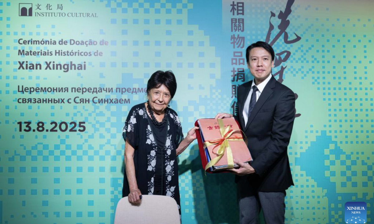 Baldyrgan Baikadamova (L), the daughter of Kazakh musician Bakhytzhan Baikadamov, donates Xian Xinghai items she has kept, at a donation ceremony held in Macao, south China, Aug. 13, 2025. The Cultural Affairs Bureau (IC) of China's Macao Special Administrative Region (SAR) government on Wednesday held a donation ceremony for items related to Xian Xinghai, a late Chinese composer remembered by generations. (Xinhua/Cheong Kam Ka)